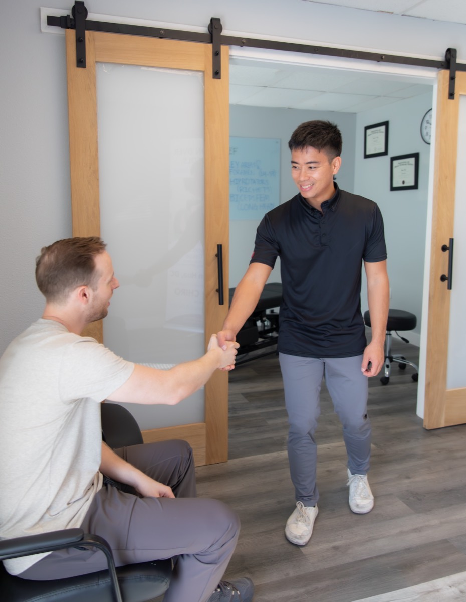 Dr. Jaron Hua welcoming a patient to his treatment room